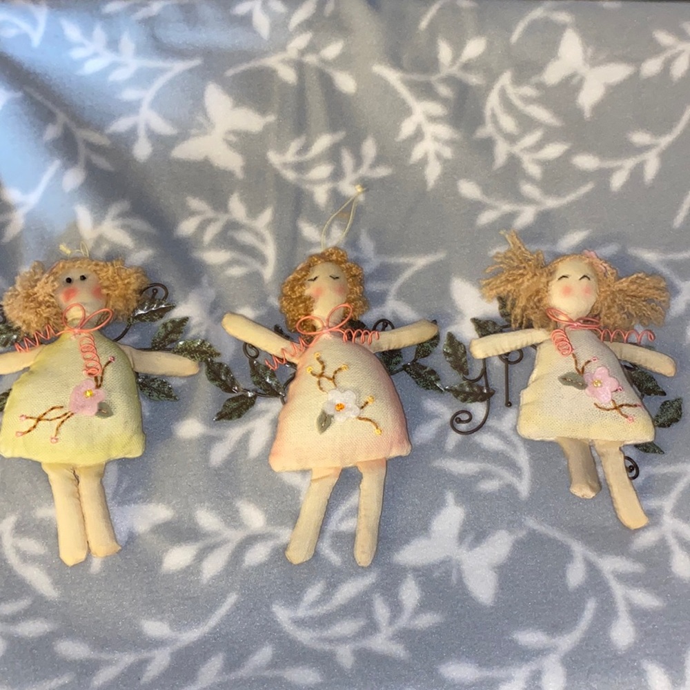 Set of cloth dolls with metal wings.